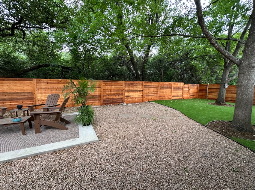 Horizontal cedar wood fence with landscaped backyard